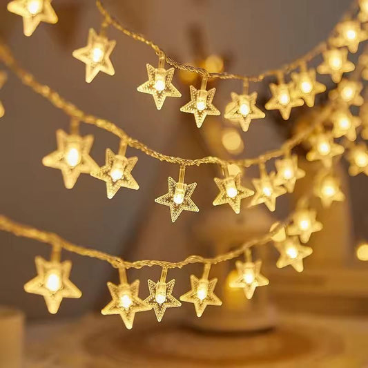 String of star-shaped lights with a warm glow on a blurred background