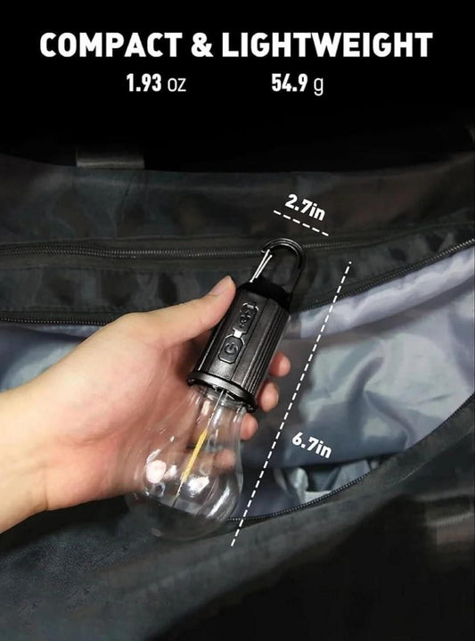 Hand holding a compact flashlight next to a black bag with measurements displayed.
