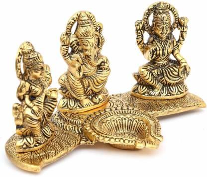 Set of three gold-colored deity statues on a white background