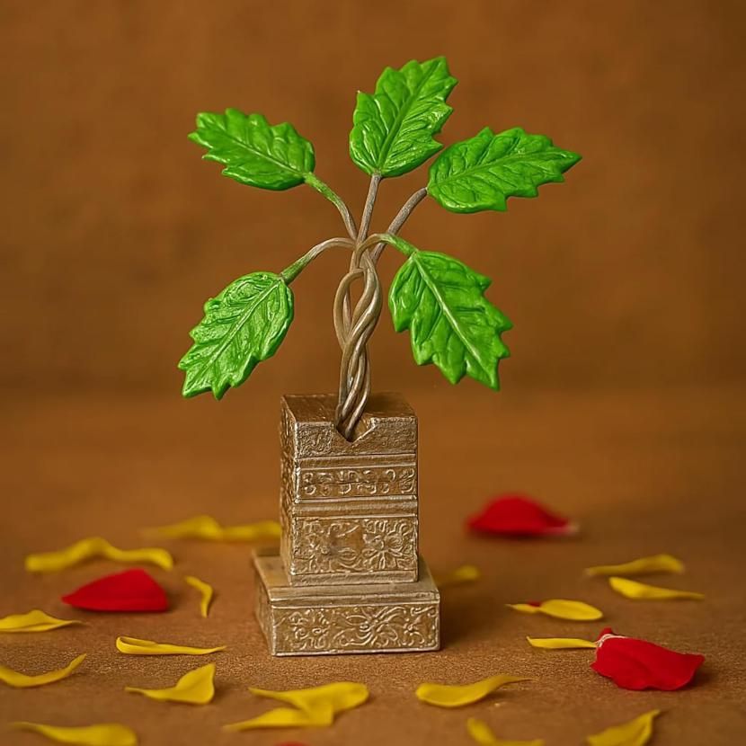 Decorative metal plant with green leaves on a brown background