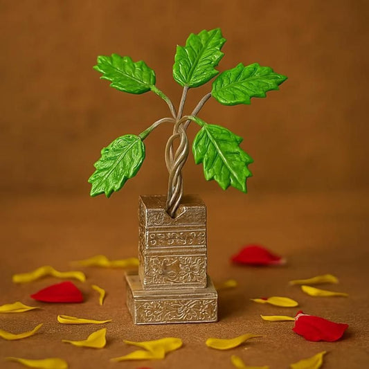 Decorative metal plant with green leaves on a brown background