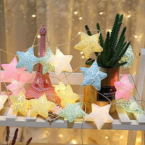 Star-shaped string lights on a decorative surface with a blurred background