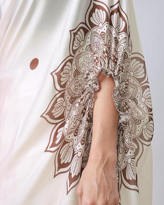 Close-up of a hand wearing a bracelet with intricate brown and white pattern on a light fabric background