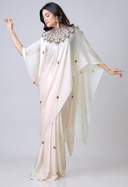 Woman wearing a cream saree with a textured blouse on a white background