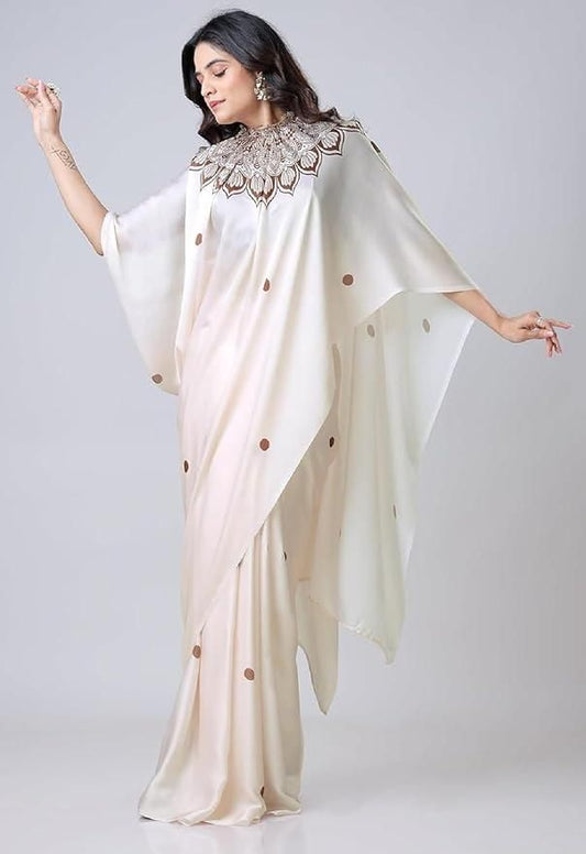 Woman wearing a cream saree with a textured blouse on a white background
