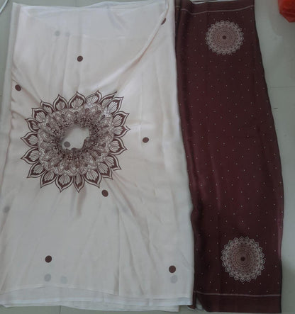 White fabric with brown mandala patterns on a plain background