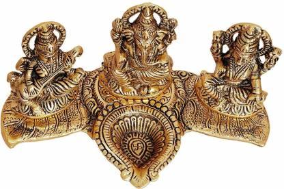 Decorative brass sculpture of a figure with two smaller figures on either side on a white background