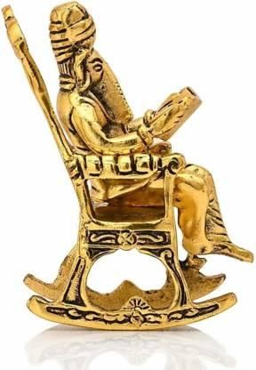 Gold-colored bottle opener shaped like a person sitting on a chair with a book.