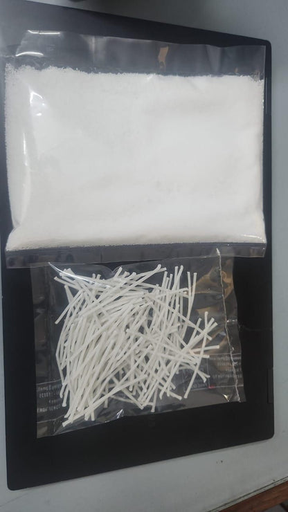 Two clear plastic bags containing white cotton swabs and cotton balls on a dark surface.
