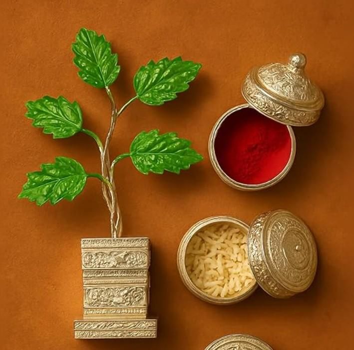 Decorative items including a green leafy branch, red powder, and gold containers on an orange background
