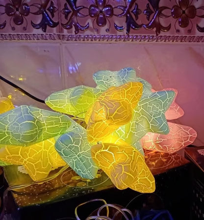 String lights shaped like leaves with a decorative background