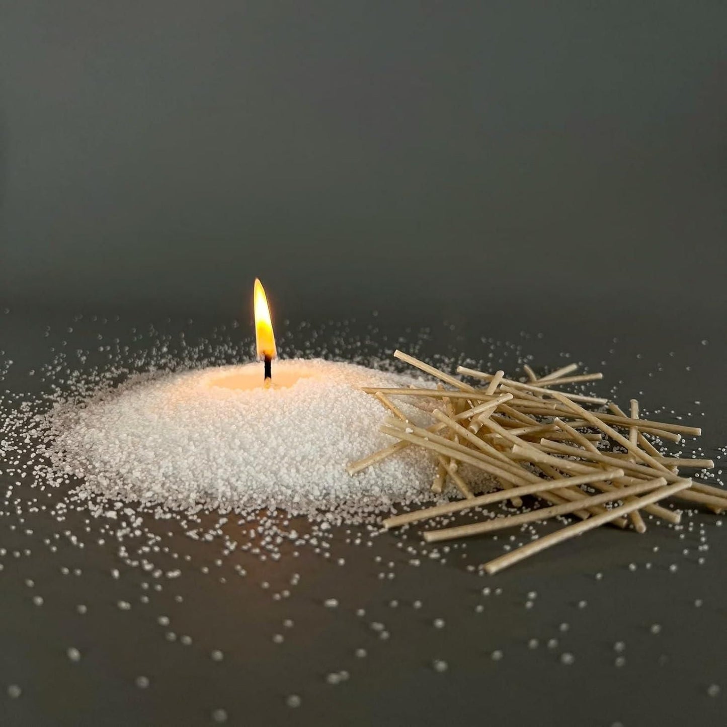 Candle with matches on a dark background