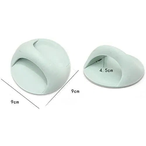 Two light green silicone door stoppers with measurements on a white background