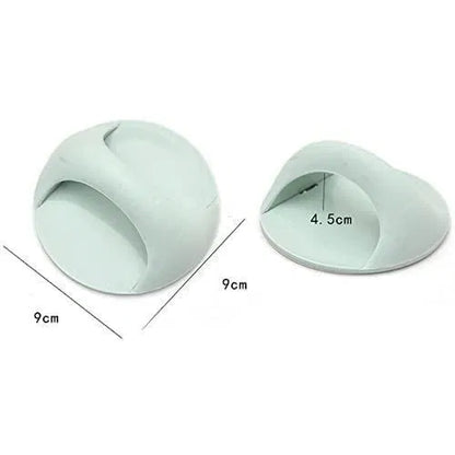 Two light green silicone door stoppers with measurements on a white background