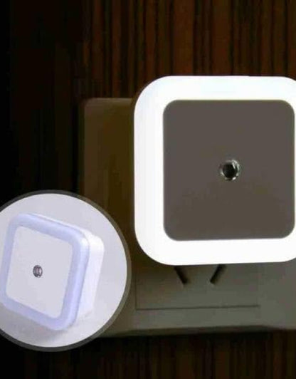 Square night light attached to a wall socket with close-up inset showing LED light.
