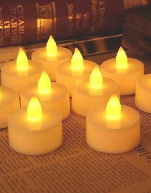 Set of small yellow candles on a newspaper background