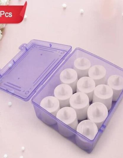Set of white LED  Candles in a purple container on a light pink background