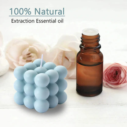 Blue bubble candle and brown essential oil bottle with flowers on a white background