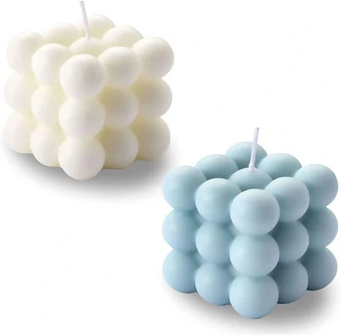 Two bubble-style candles, one white and one light blue, on a white background.